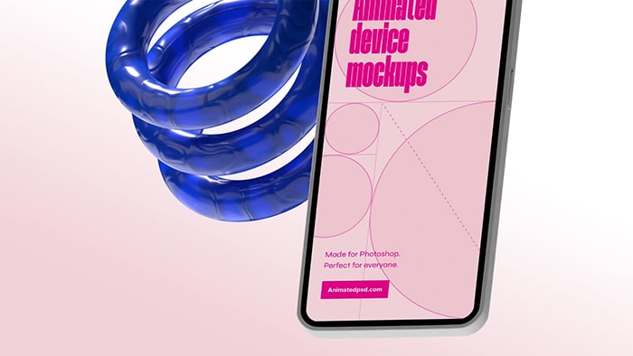 Closeup of a mobile device on a light background with a decorative blue spring behind it