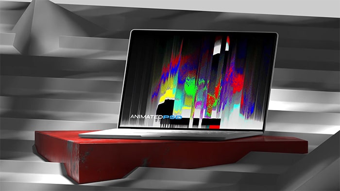 Open laptop sitting on red plinth and on steps with shadows cast all around