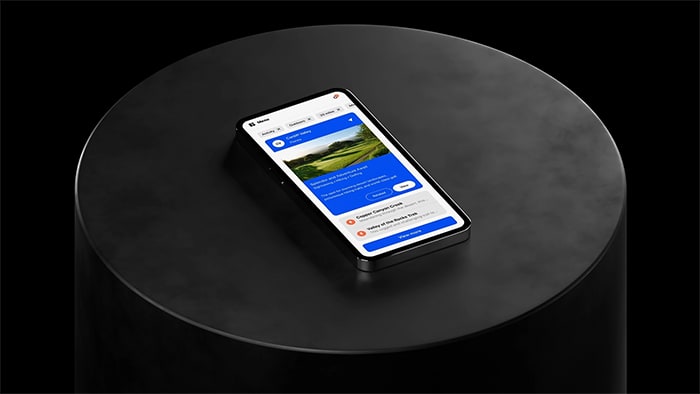 Mobile device sitting on cylindrical black plinth