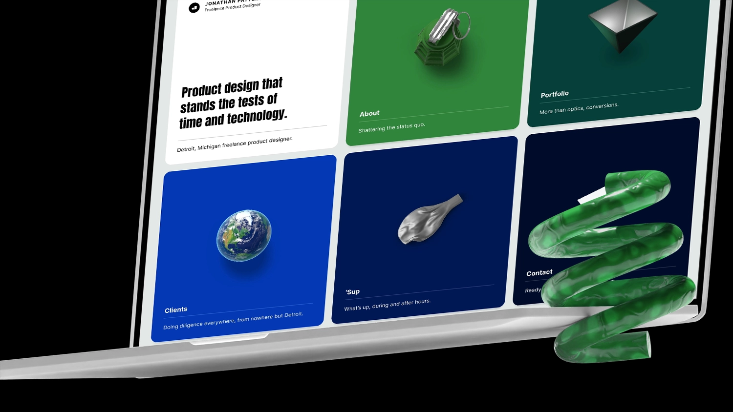 An open laptop on a dark background with a decorative green spring object