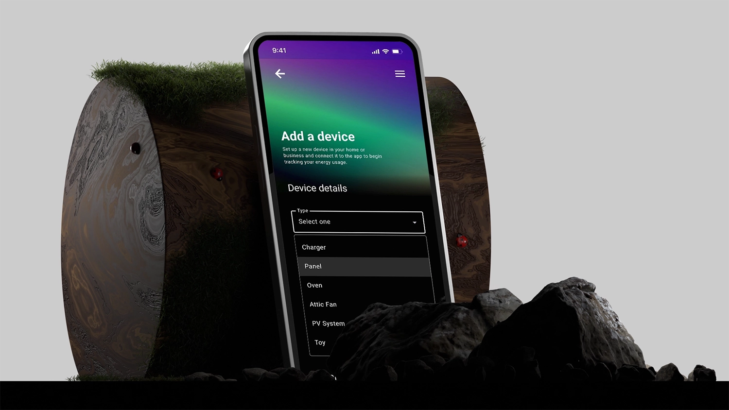 A mobile device leaning against a wooden log with a light background