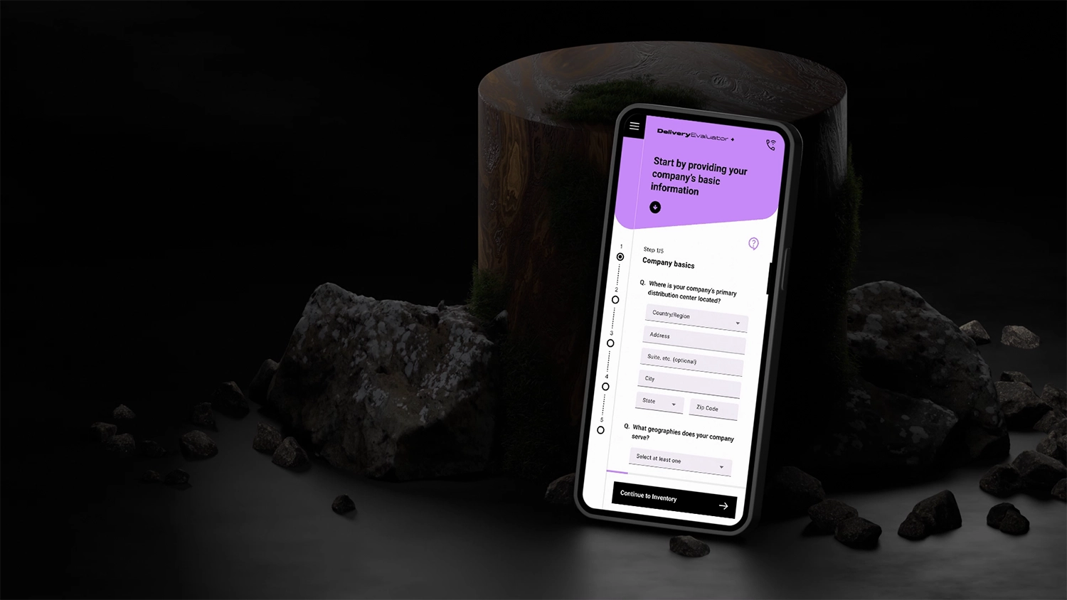 Mobile device leaning against an upright wooden log with rocks all around