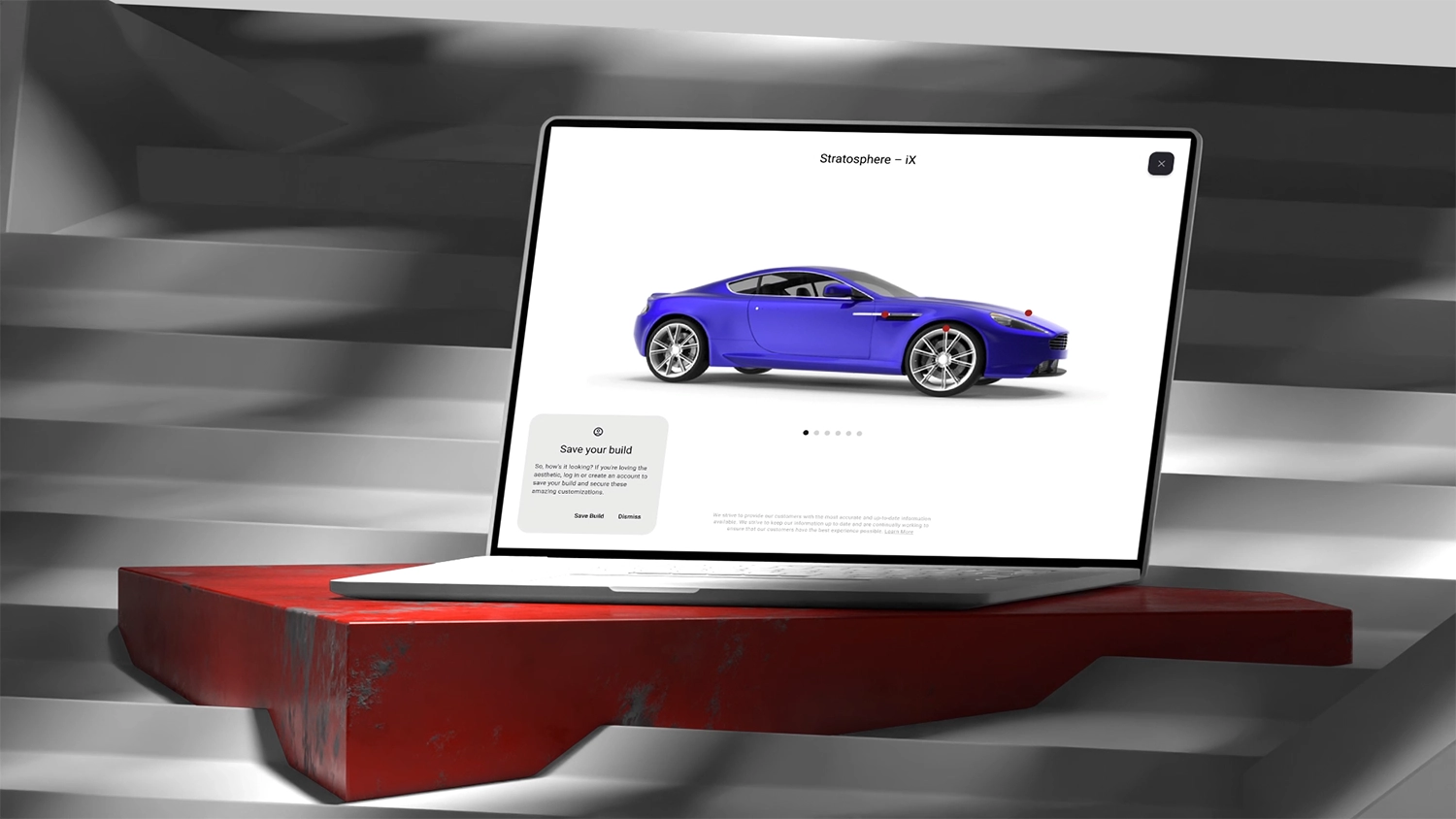 Open laptop sitting on red plinth and on steps with shadows cast all around