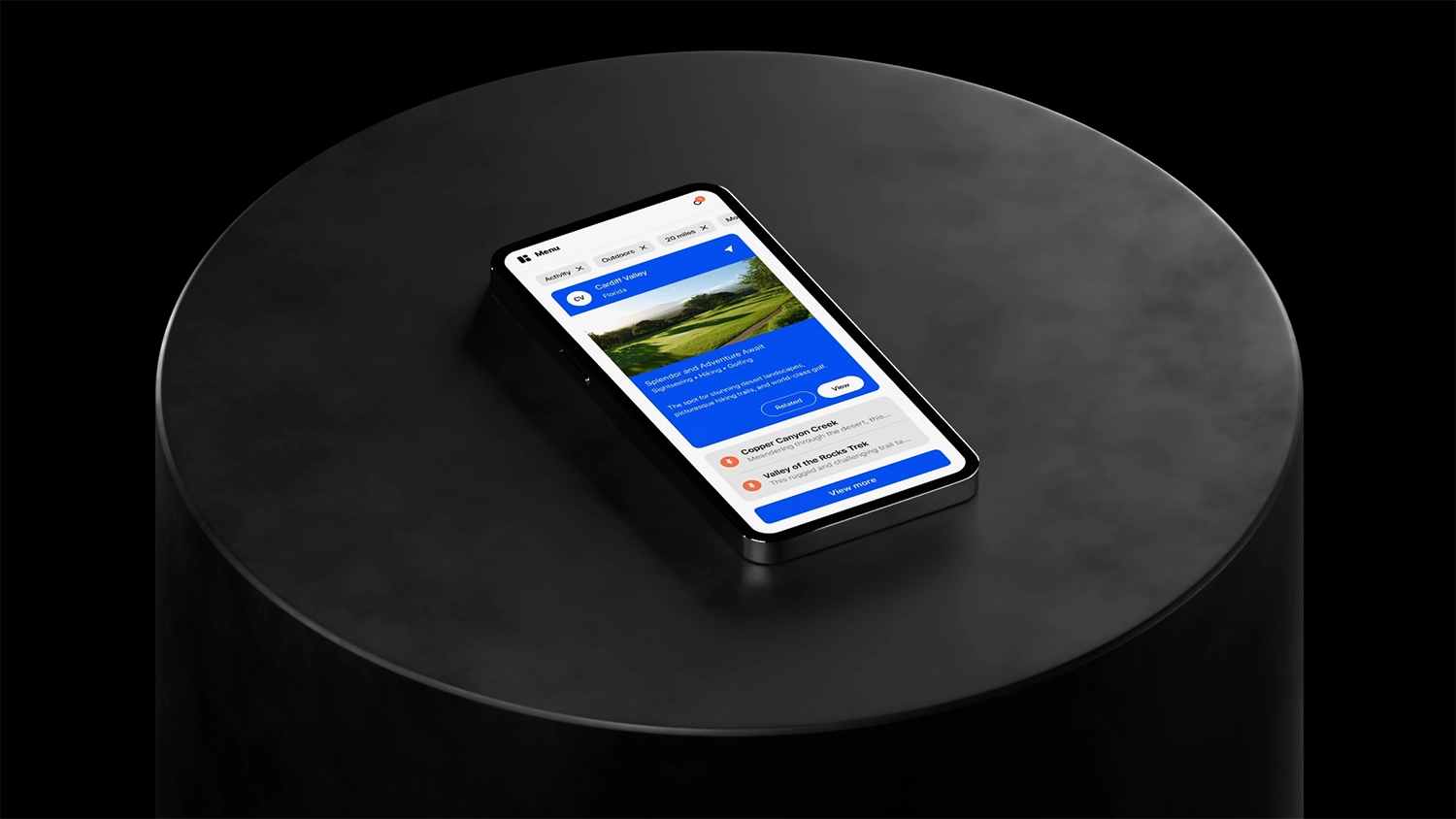 A mobile device sitting on cylindrical black plinth with a dark background